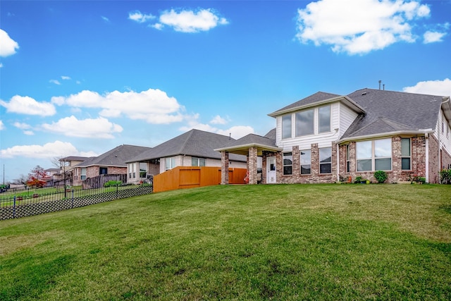 rear view of property with a yard