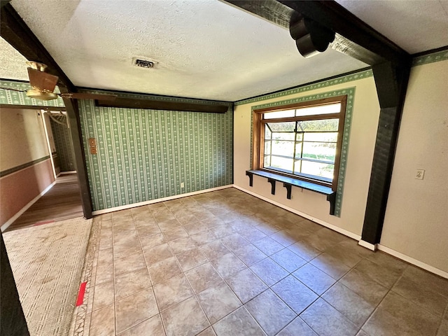 unfurnished bedroom featuring tile patterned floors and a textured ceiling