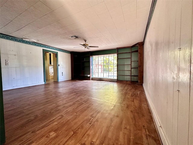 empty room featuring ceiling fan and wood-type flooring