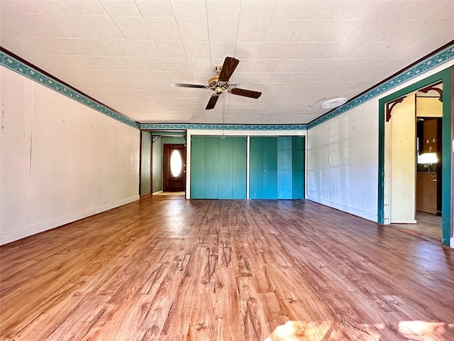 unfurnished living room with ceiling fan and light hardwood / wood-style flooring