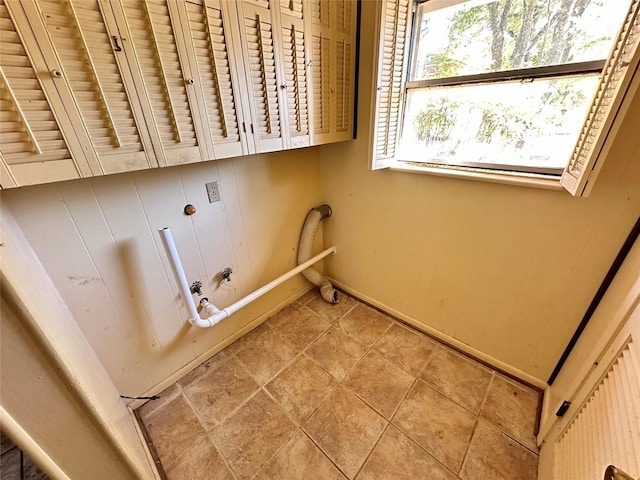 washroom with tile patterned flooring and cabinets