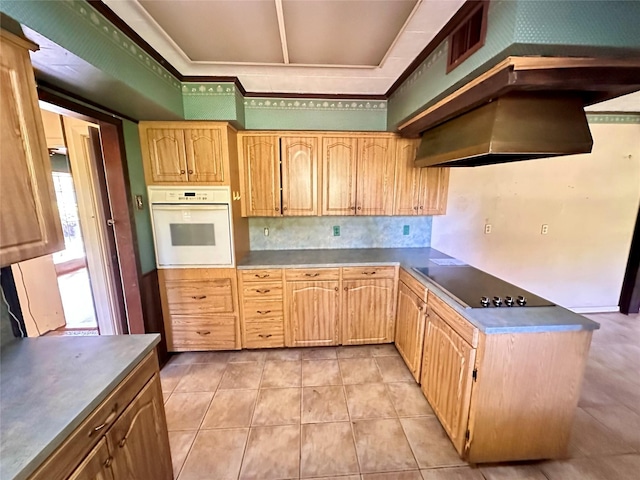 kitchen featuring decorative backsplash, black electric stovetop, ventilation hood, light tile patterned floors, and oven