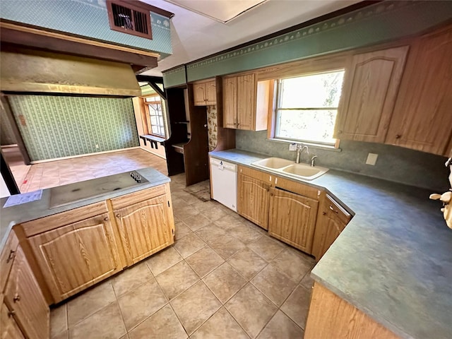 kitchen featuring light tile patterned flooring, white dishwasher, a wealth of natural light, and sink