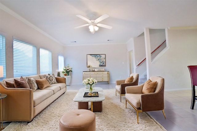 living room featuring crown molding, light tile patterned flooring, and ceiling fan