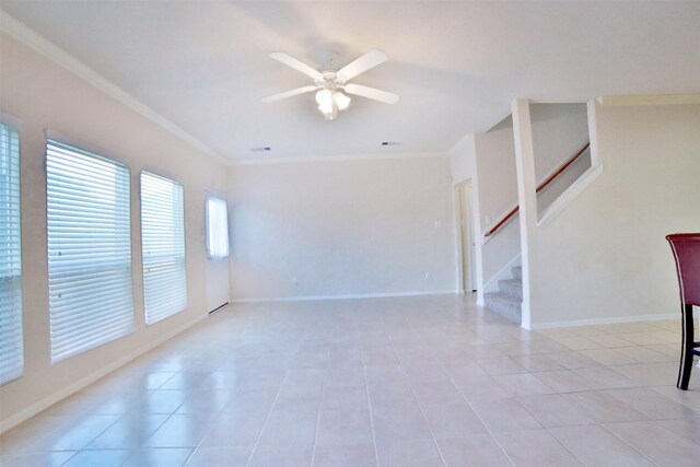 spare room with ceiling fan, light tile patterned flooring, and ornamental molding