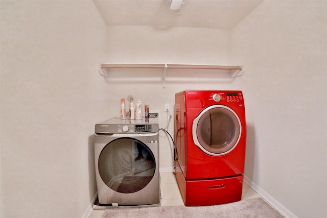 clothes washing area with washing machine and dryer