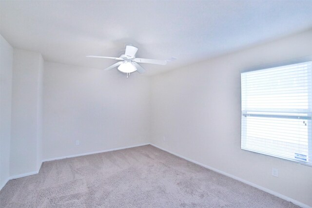 carpeted empty room featuring plenty of natural light and ceiling fan