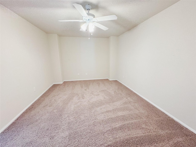 empty room featuring ceiling fan, carpet floors, and a textured ceiling