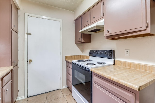 kitchen featuring light tile patterned flooring and electric stove