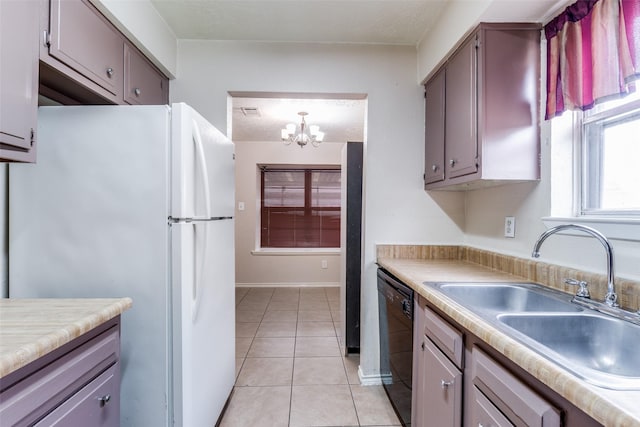 kitchen featuring sink, light tile patterned floors, an inviting chandelier, black dishwasher, and white fridge