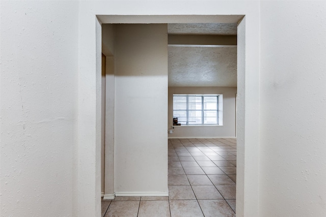 corridor with light tile patterned floors