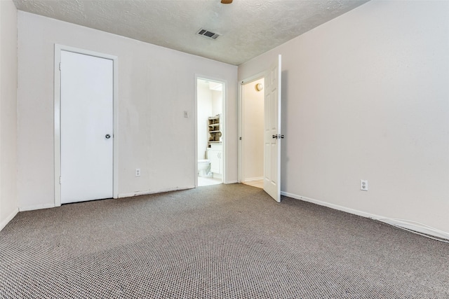 unfurnished bedroom with ceiling fan, carpet floors, and a textured ceiling