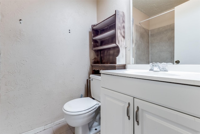 bathroom with toilet, a shower, vanity, and tile patterned floors