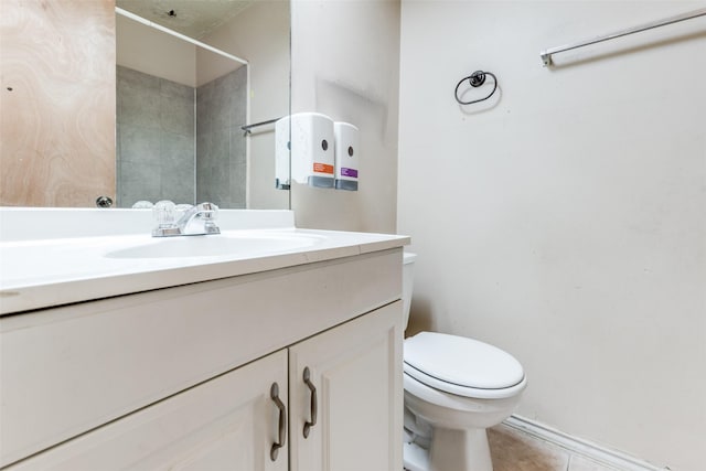 bathroom featuring tile patterned flooring, vanity, and toilet