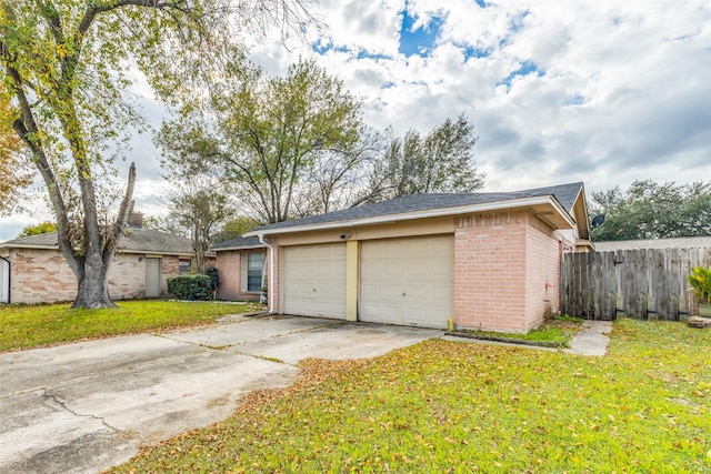 garage featuring a lawn