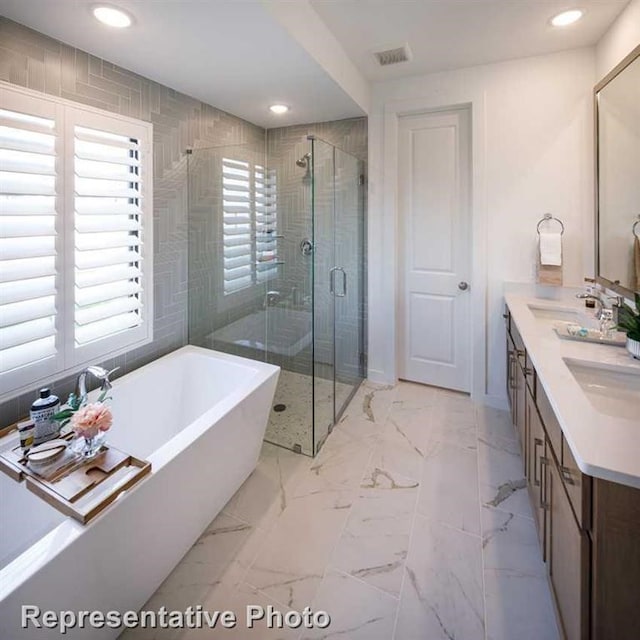 bathroom featuring plus walk in shower and vanity