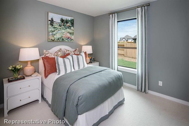 bedroom with light carpet and multiple windows