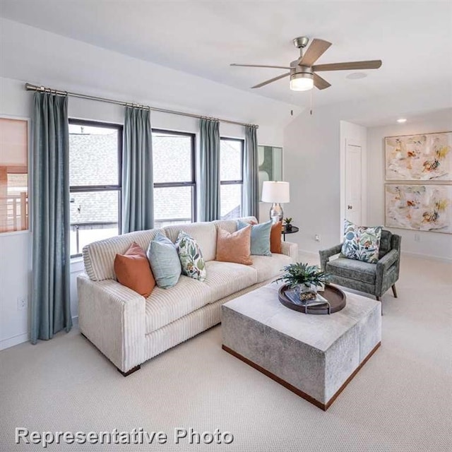 carpeted living room featuring ceiling fan