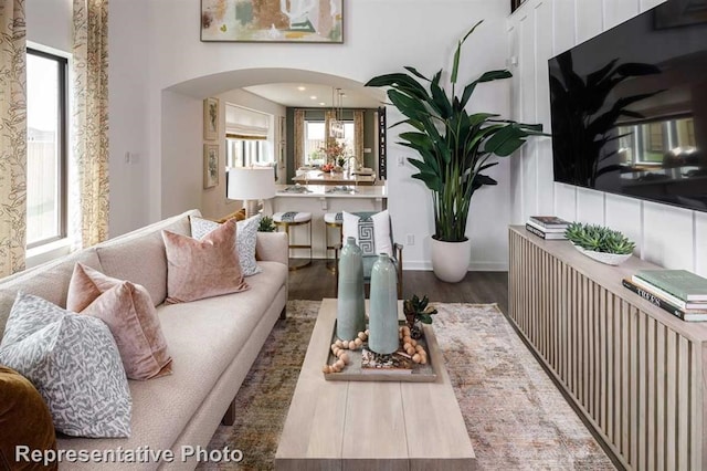 living room with dark hardwood / wood-style floors and plenty of natural light