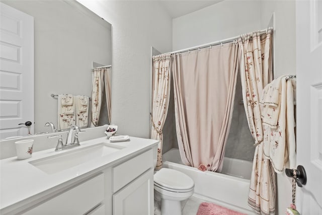 full bathroom with vanity, shower / bath combo, and toilet