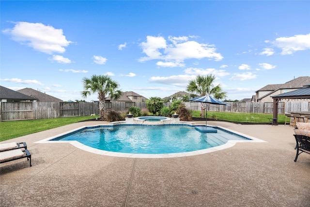 view of pool featuring a lawn, a patio area, and an in ground hot tub