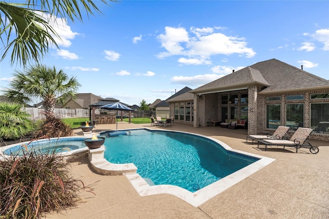 view of swimming pool with an in ground hot tub, a gazebo, and a patio area