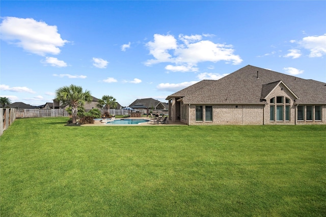 view of yard with a fenced in pool