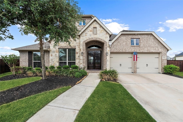 view of front facade featuring a front lawn, a garage, and french doors