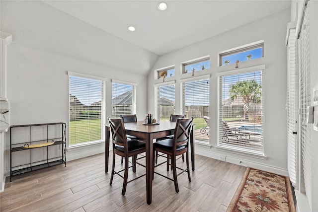 dining room featuring lofted ceiling