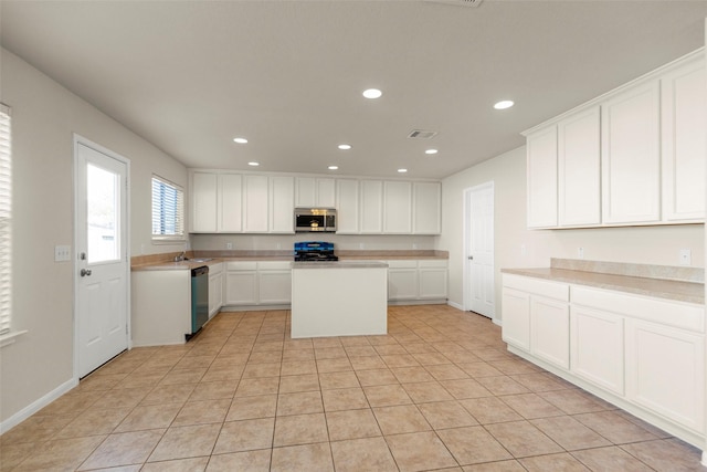 kitchen featuring a center island, white cabinetry, stainless steel appliances, and light tile patterned floors