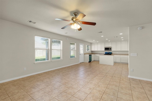 unfurnished living room with ceiling fan and light tile patterned floors