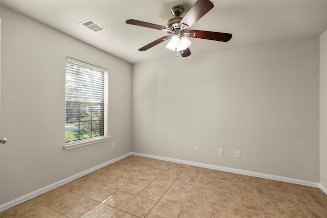 tiled spare room with ceiling fan