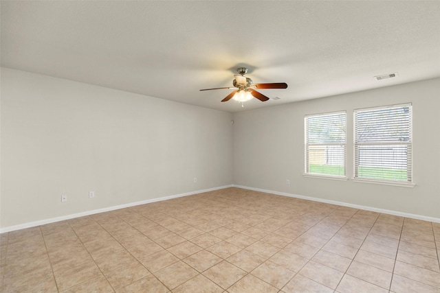 empty room featuring light tile patterned floors and ceiling fan