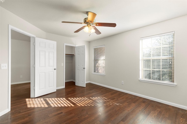 unfurnished bedroom featuring ceiling fan, dark hardwood / wood-style floors, and a closet