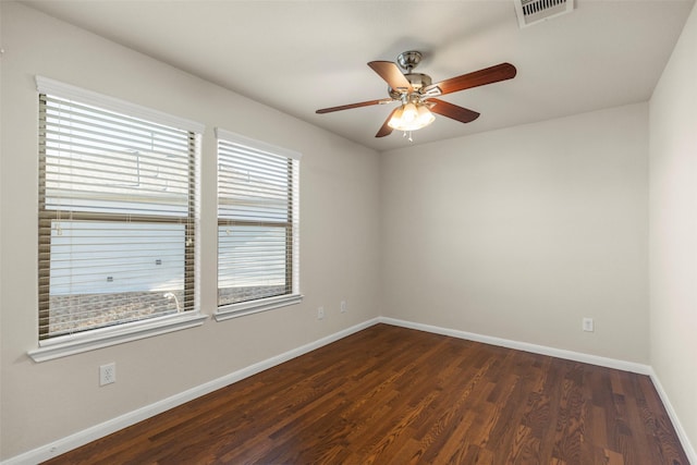 empty room featuring ceiling fan and dark wood-type flooring