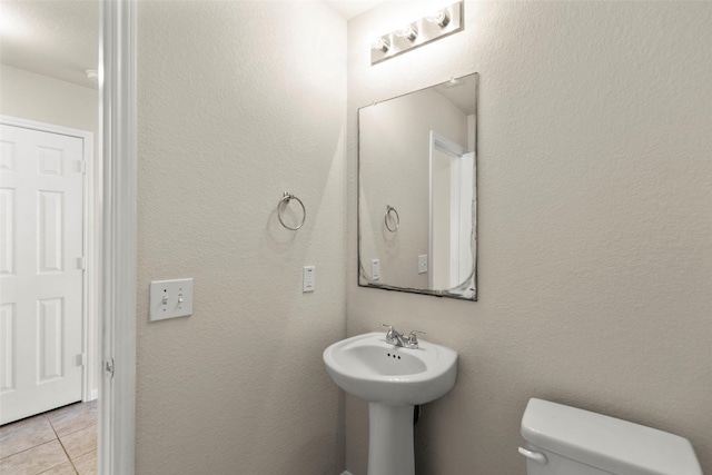 bathroom featuring tile patterned flooring and toilet