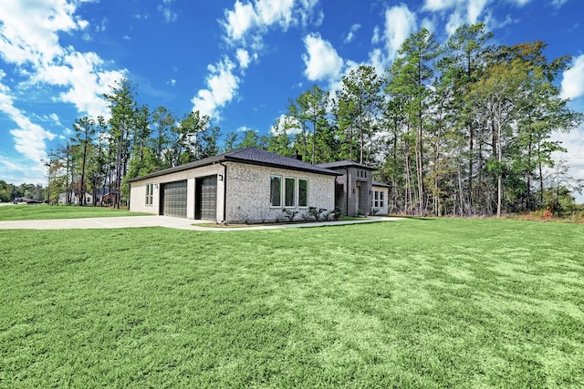 view of side of property featuring a yard and a garage