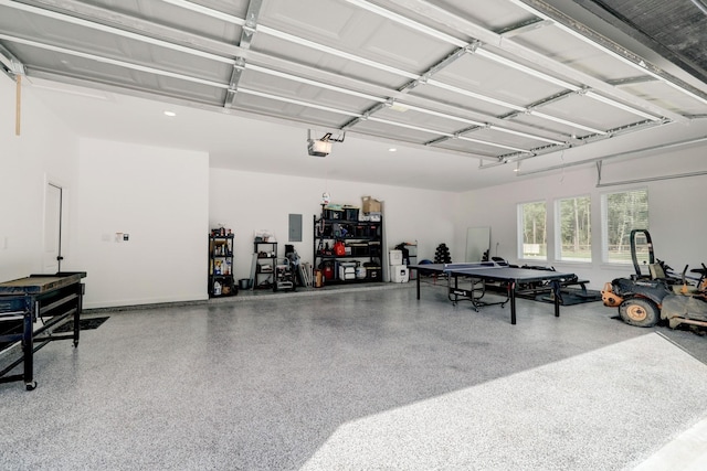 garage with electric panel and a garage door opener