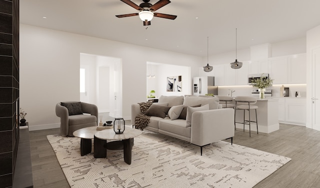 living room with ceiling fan and light hardwood / wood-style flooring