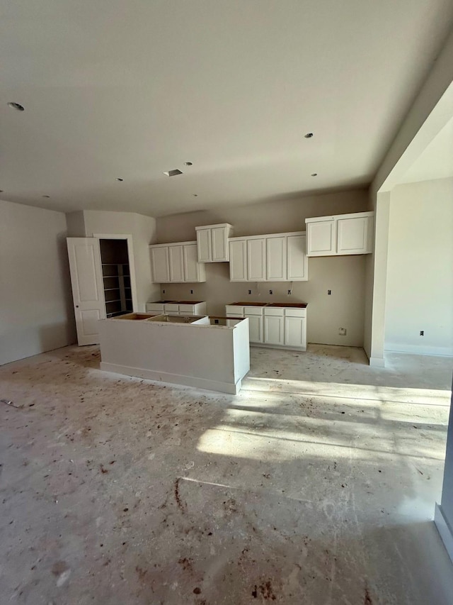 kitchen featuring a kitchen island and white cabinetry