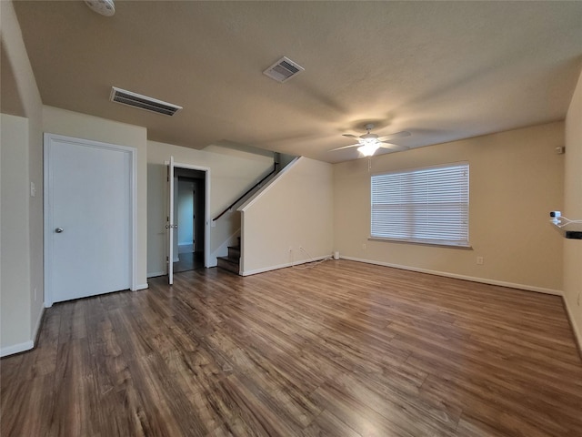 unfurnished living room featuring dark hardwood / wood-style floors and ceiling fan