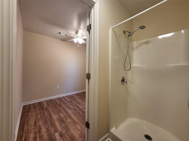 bathroom with a shower and wood-type flooring