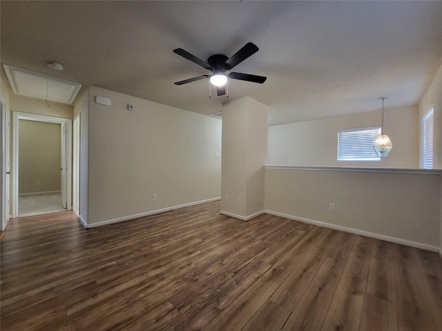 empty room featuring dark hardwood / wood-style flooring and ceiling fan