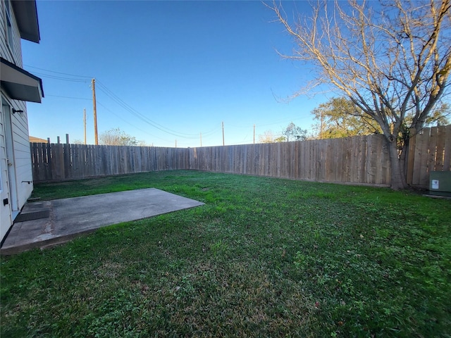 view of yard with cooling unit and a patio area