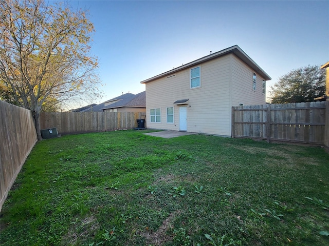 back of property featuring a lawn and a patio