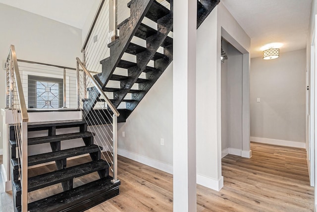 stairs featuring hardwood / wood-style flooring