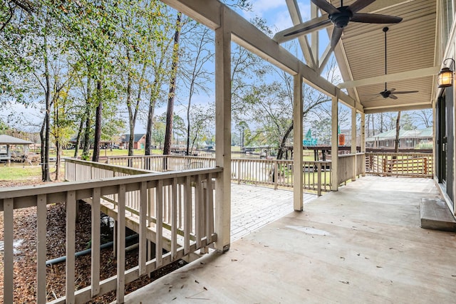 view of patio with ceiling fan and a deck