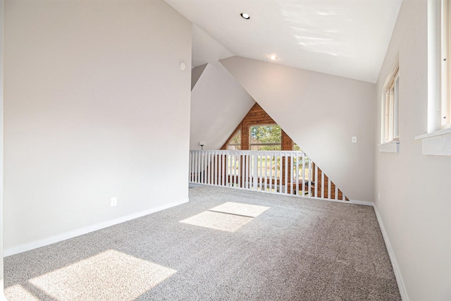 bonus room with carpet and vaulted ceiling