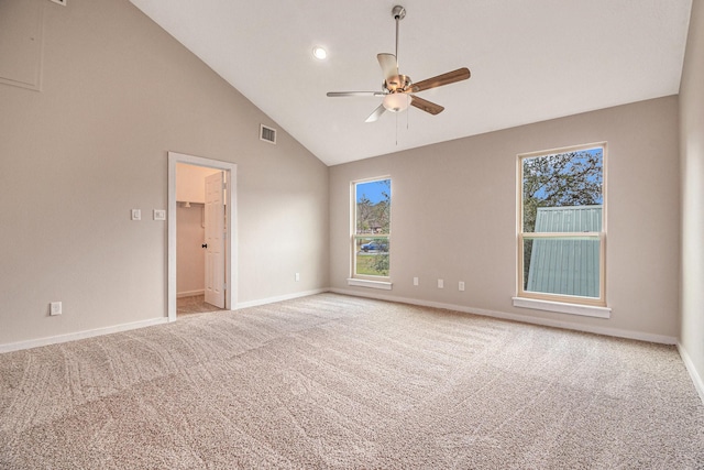 carpeted empty room with ceiling fan and high vaulted ceiling