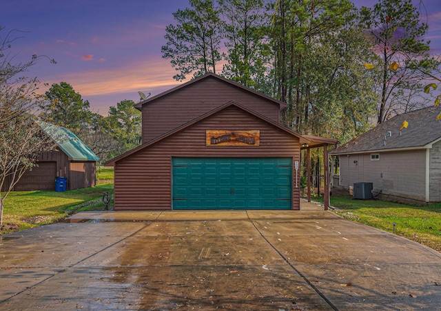 garage at dusk featuring central AC